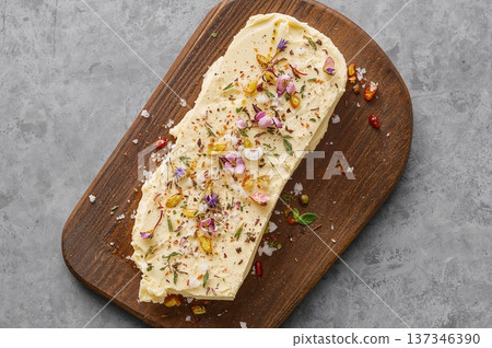 Artistic butter spread with herbs salt and flowers in modern rustic appetizer scene 137346390