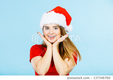 Positive woman wearing Santa Claus helper costume Positive woman wearing Santa Claus helper costume 137346760