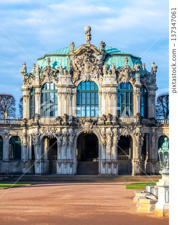 Zwinger palace in Dresden showcases Baroque architecture. Visitors explore the gardens and gallery while enjoying the Christmas decorations and festive atmosphere in the winter season. 137347061