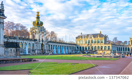 Visitors explore the Zwinger Palace in Dresden, Germany. This historic site features gardens and galleries. Christmas decorations enhance the beauty of the Baroque architecture in winter. Visitors explore the Zwinger Palace in Dresden, Germany. This historic site features gardens and galleries. Christmas decorations enhance the beauty of the Baroque architecture in winter. 137347062
