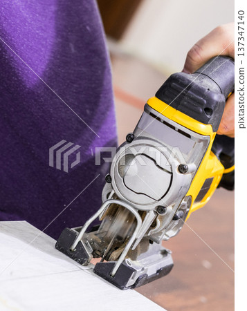 Person cutting floor panels Person cutting floor panels 137347140