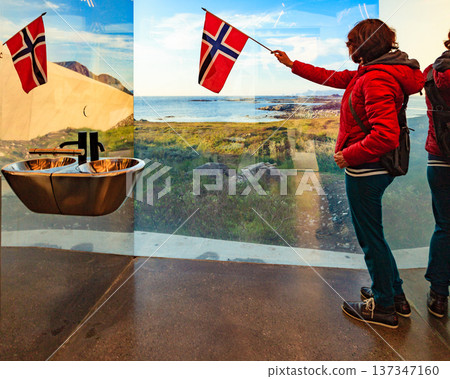 Tourist with norwegian flag in mirrored toilet, Andoy Norway Tourist with norwegian flag in mirrored toilet, Andoy Norway 137347160