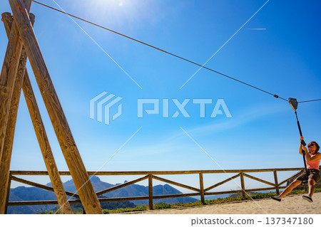 Adult woman having fun on zipline 137347180