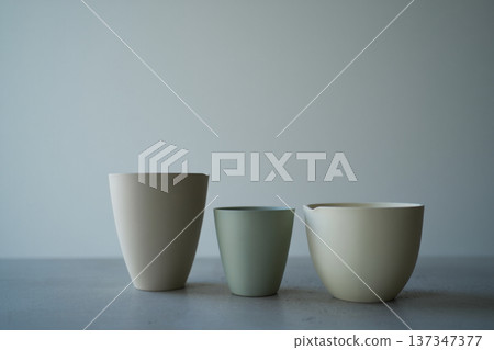 white cups on gray background 137347377