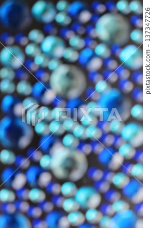 Blurred Pattern Of Round Rhinestones Shining With Variety Shades Of Blue. Defocused Stock Photo For Vertical Story Blurred Pattern Of Round Rhinestones Shining With Variety Shades Of Blue. Defocused Stock Photo For Vertical Story 137347726