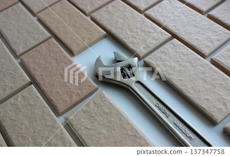 Head Of Adjustable Spanner Inside Decorative Brickwork. Stock Photo For House Repairing Illustration 137347758