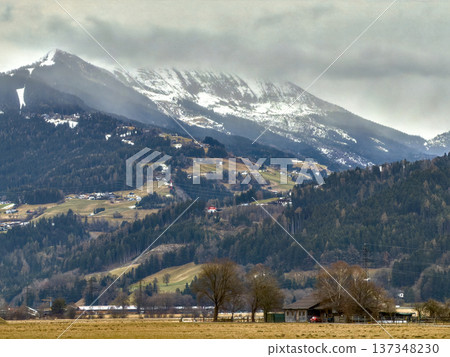 Idyllic Rural Community Situated Beside Majestic Snowy Summits And Lush Fields Idyllic Rural Community Situated Beside Majestic Snowy Summits And Lush Fields 137348230