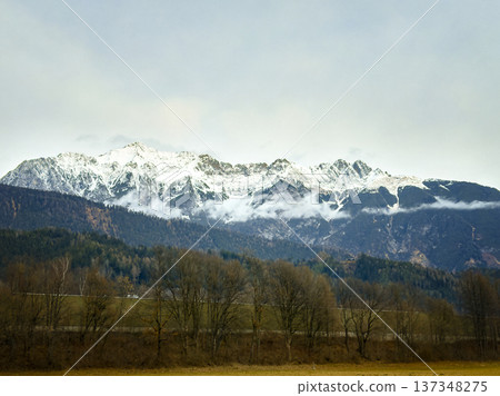 Vast Snowcovered Mountains Amid Foggy Trees And Cool Atmosphere Vast Snowcovered Mountains Amid Foggy Trees And Cool Atmosphere 137348275