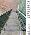 Outdoor metal staircase leading down forest path 137348603