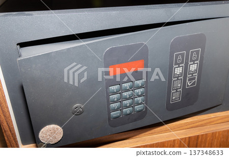 Open electronic hotel safe with keypad inside wooden cabinet Open electronic hotel safe with keypad inside wooden cabinet 137348633