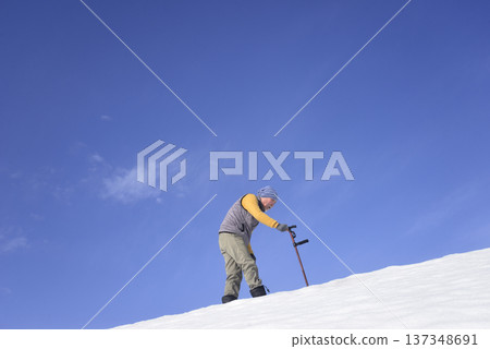 An elderly man living in a snowy rural area is using a walking stick for rehabilitation An elderly man living in a snowy rural area is using a walking stick for rehabilitation 137348691
