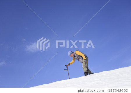 An elderly man living in a snowy rural area is using a walking stick for rehabilitation An elderly man living in a snowy rural area is using a walking stick for rehabilitation 137348692