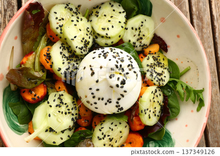Fresh burrata cheese served with tomato and avocado salad, seasoned with olive oil and natural ingredients. This Mediterranean style dish highlights healthy food, vibrant colors, and gourmet presentat Fresh burrata cheese served with tomato and avocado salad, seasoned with olive oil and natural ingredients. This Mediterranean style dish highlights healthy food, vibrant colors, and gourmet presentat 137349126