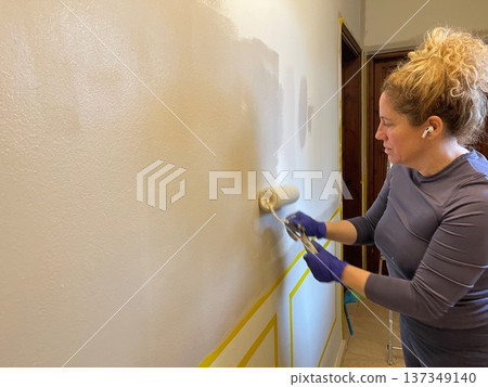 Woman Doing Home Repair and Painting 137349140