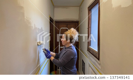 Woman Doing Home Repair and Painting 137349141