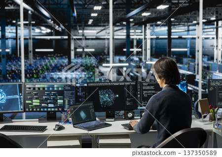 Data center computer scientist running simulations for AI driven forecasting, tracking performance. Server hub IT professional integrating machine learning APIs into software platforms Data center computer scientist running simulations for AI driven forecasting, tracking performance. Server hub IT professional integrating machine learning APIs into software platforms 137350589