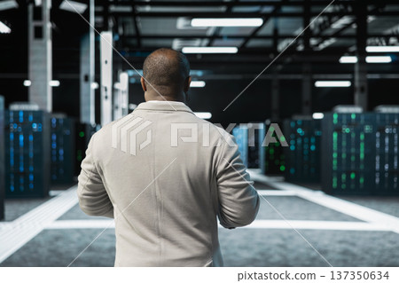African american admin doing yearly checkup to prolong data center electronics life span and avoid downtime. IT employee in server room monitoring server infrastructure components 137350634
