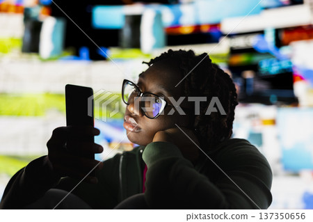 Apathetic woman addicted to social media, unable to stop using smartphone, wasting her life. Couch potato person staring at phone screen, concept of technology overuse and digital dependence 137350656
