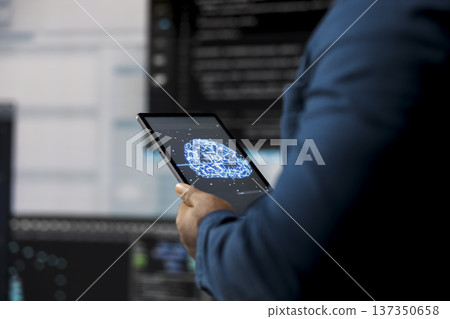 In a futuristic digital workspace, black developer programming software and explores code snippets. Tech professional embodies innovation, cybersecurity, automation and development. 137350658