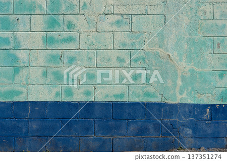 Faded green and blue old concrete block wall 137351274