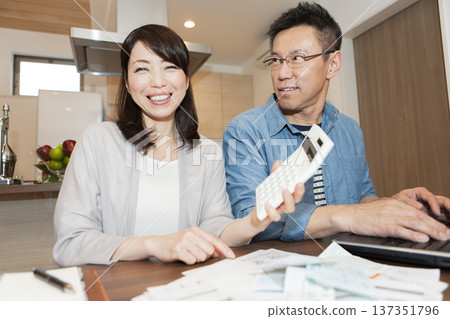 A middle-aged couple creating a household account book 137351796