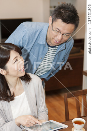 Middle-aged couple with a tablet PC Middle-aged couple with a tablet PC 137351806