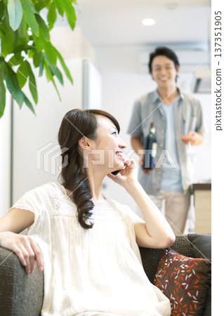 Couple talking on the phone on the sofa 137351905