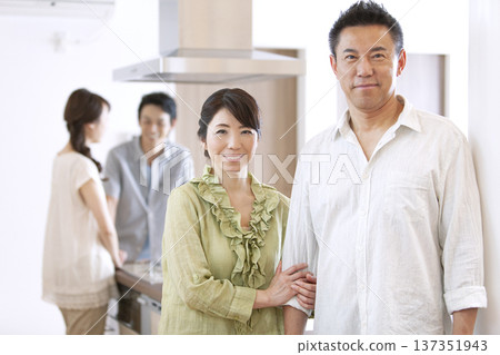 Two-generation family talking in the kitchen 137351943