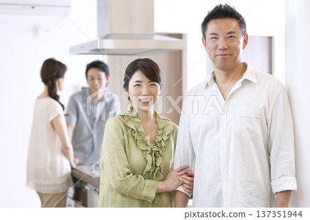 Two-generation family talking in the kitchen Two-generation family talking in the kitchen 137351944
