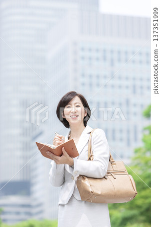 Career woman with a notebook Career woman with a notebook 137351999