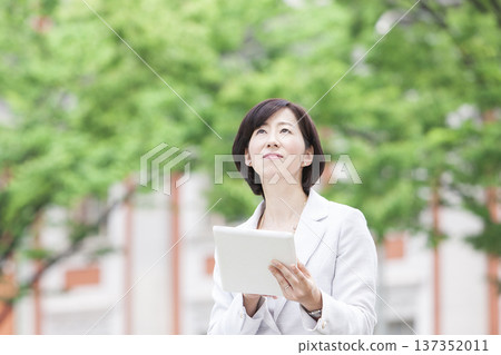 一位職業婦女正在操作平板電腦 137352011