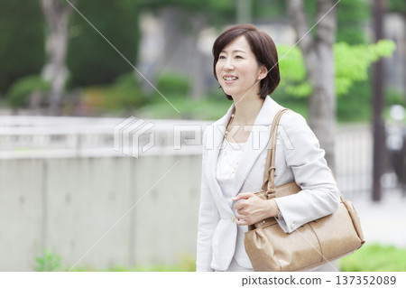 Career woman walking in the office district Career woman walking in the office district 137352089