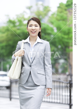 businesswoman walking in office businesswoman walking in office 137352129