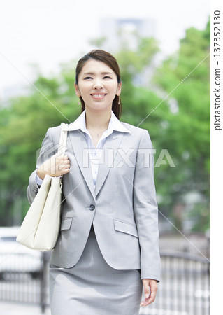 businesswoman walking in office businesswoman walking in office 137352130