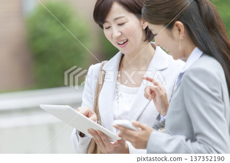 Two businesswomen looking at a tablet 137352190