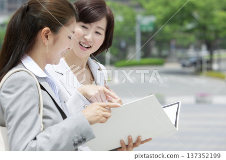 Two businesswomen looking at documents 137352199