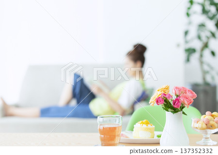A woman reading on a sofa A woman reading on a sofa 137352332
