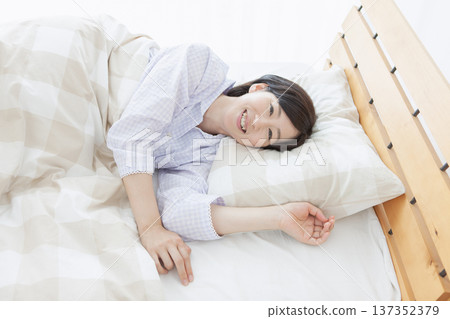 Middle-aged woman sleeping in bed 137352379