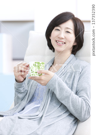 Middle aged women with tea cups Middle aged women with tea cups 137352390