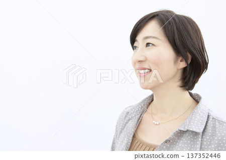 Profile of a smiling middle-aged woman Profile of a smiling middle-aged woman 137352446