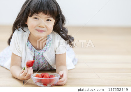 A girl who eats strawberries A girl who eats strawberries 137352549