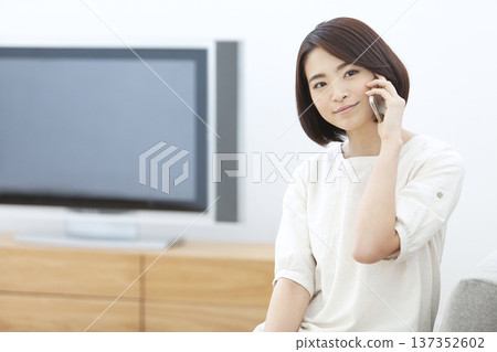 Woman calling on a smartphone Woman calling on a smartphone 137352602