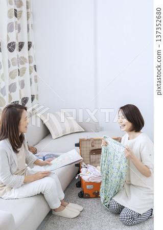 Mother and daughter preparing for a trip 137352680
