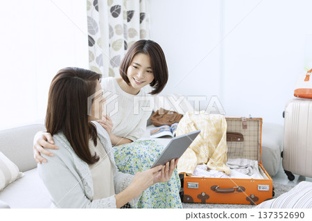 Mother and daughter preparing for a trip Mother and daughter preparing for a trip 137352690