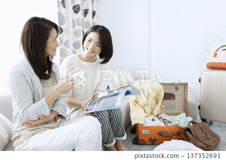 Mother and daughter preparing for a trip Mother and daughter preparing for a trip 137352691