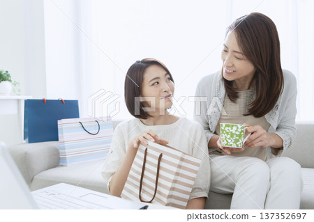 Mother and daughter shopping online Mother and daughter shopping online 137352697