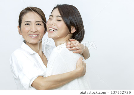 A mother hugging her daughter A mother hugging her daughter 137352729