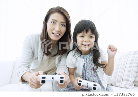 Grandmother and grandson playing video games Grandmother and grandson playing video games 137352766