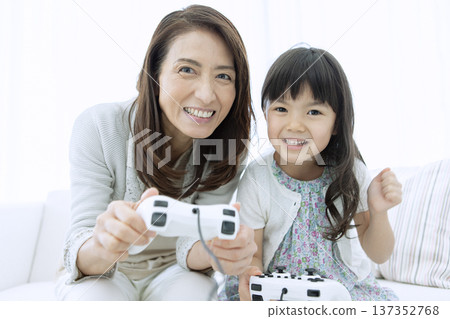 Grandmother and grandson playing video games Grandmother and grandson playing video games 137352768