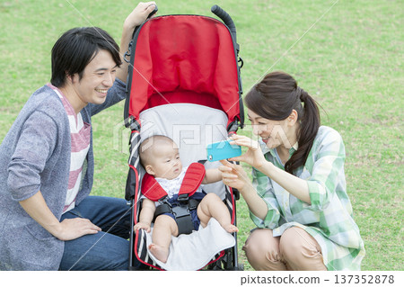 Family taking photos with a smartphone Family taking photos with a smartphone 137352878